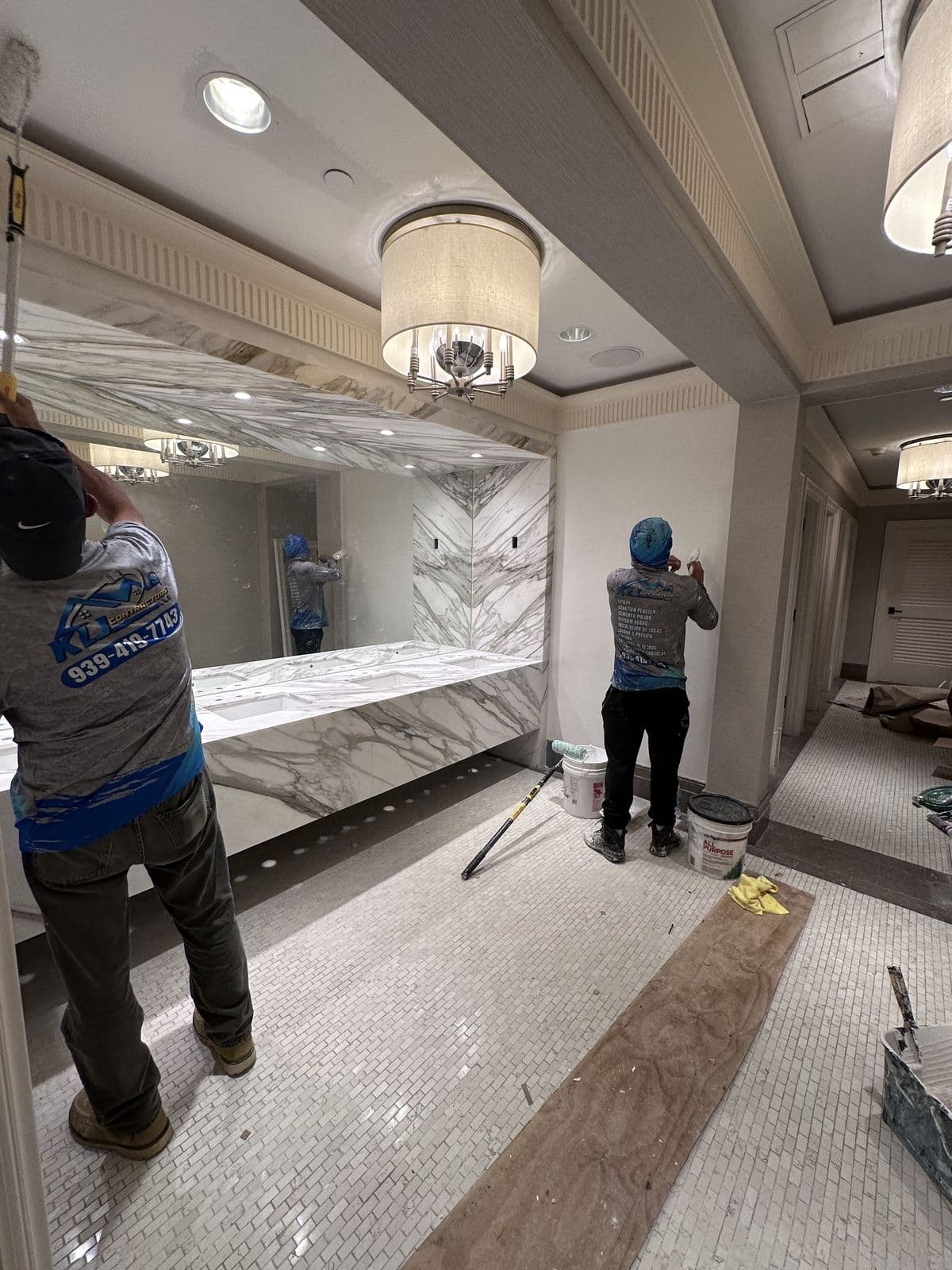 KLJ's uniformed crew painting a hotel bathroom